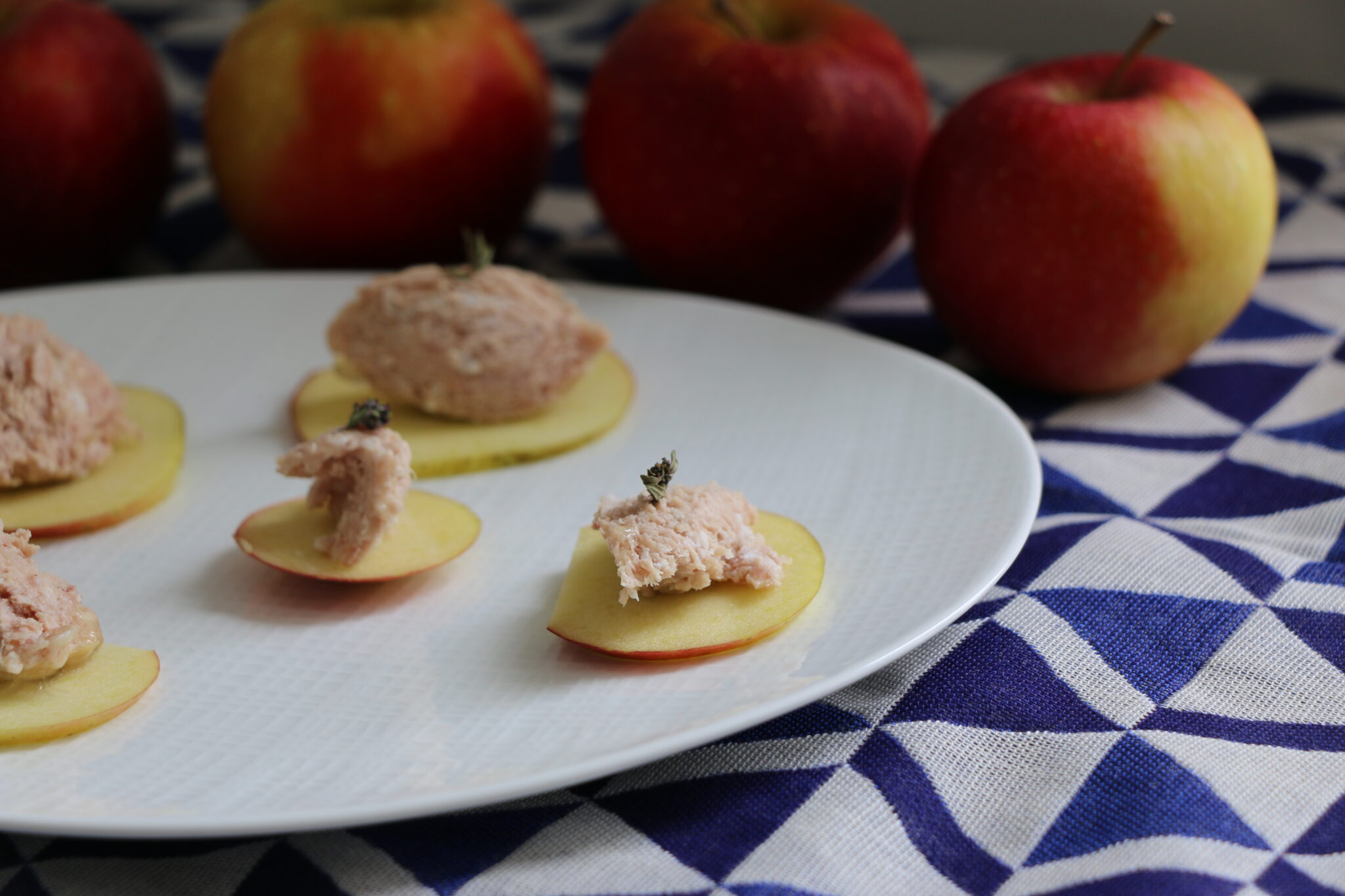 French style appetizer with pork rillettes on appel slices