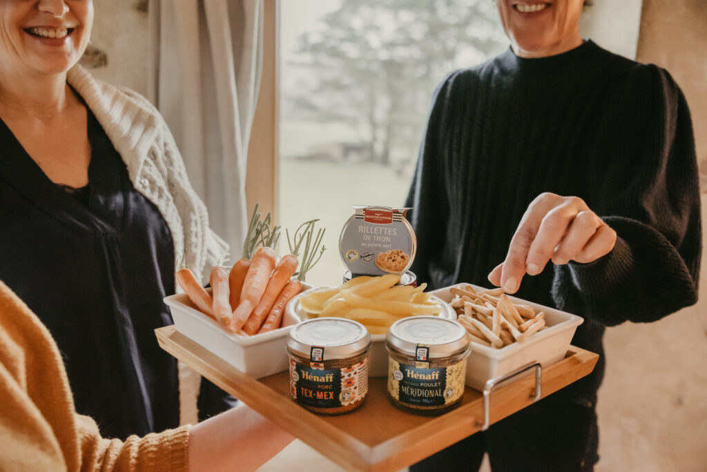 Dip appetizer with carrots, chips, preserved meat spreads in glass jars from the french cannery, Jean Hénaff and preserved fish rillettes in glass jar from the french company, Cannery Gonidec.