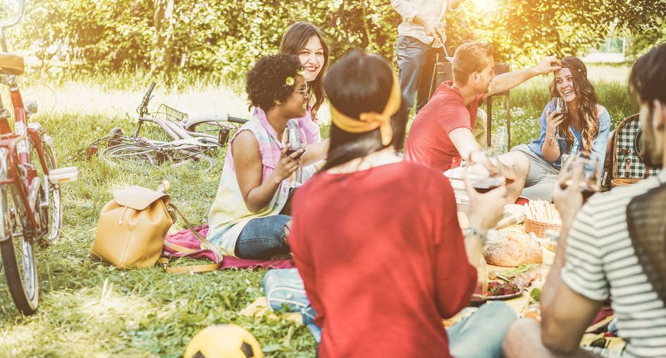 Happy friends making picnic barbecue meal outdoor