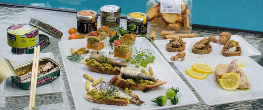 Appetizer board with Hénaff terrines in glass jars and Gonidec sardines and tuna